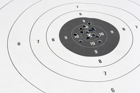 Close up of a shooting target and bullseye with bullet holesの写真素材