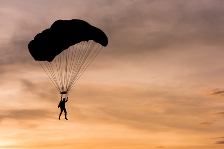 Silhouette of parachute on sunset backgroundの写真素材