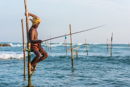 KOGGALA, SRI LANKA - MARCH 22, 2016: Local men fishing in traditional way. traditional fishermen at the evening near Galle in Sri Lanka.のeditorial素材
