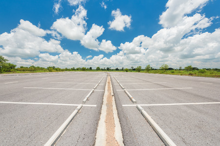 Empty parking lot against a beautiful blue skyの写真素材