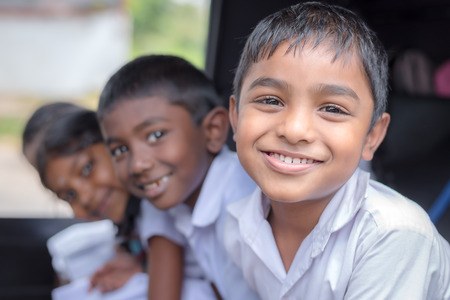KANDY, SRI LANKA - MARCH 17, 2016: Children smiling on the car before go to school and looking at...