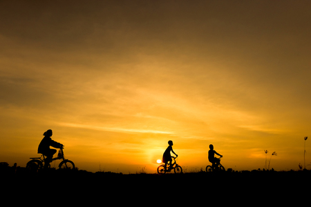 Silhouette of cycling on sunset backgroundの写真素材