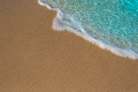 Wave of the sea on the sand beach background