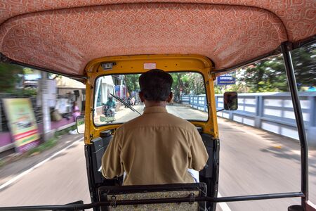 Kerala, India - May 08, 2018 : View from the inside of an auto-rickshaw, Indian Tuk Tuk taxi running for passenger service on the road in Kerala, India. Tuk-Tuk is a motorcycle have a three-wheeler (Tricycle).のeditorial素材