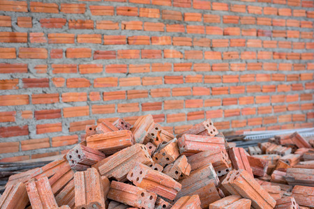 Pile of bricks with wall texture background.