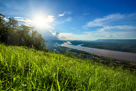 Beautiful meadow and river in sunsetの写真素材
