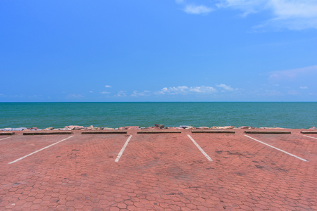 Empty parking lot against sea and beautiful blue sky.の写真素材