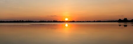 Panoramic beautiful view of sunset over the lakeの写真素材