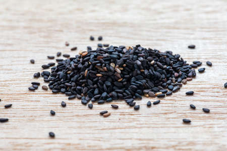 Black sesame seeds on woodの写真素材