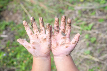 Close up of hands with mudの写真素材