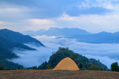 Put up a tent on mountain and beautiful misty in the morningの写真素材