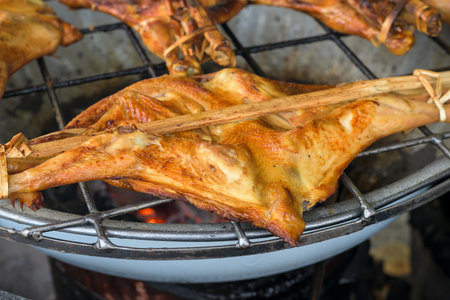 Grilled chicken on the flaming grill.の写真素材