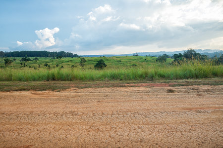 Landscape of gravel road in countryside with blue sky. Road in rainy season. Side view of dirt road on top mountain. road background.の写真素材