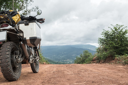 Close up of motorcycle on dirt road in countryside.の写真素材