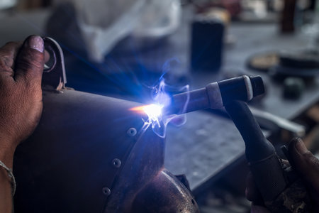 Male hand welding steel close up