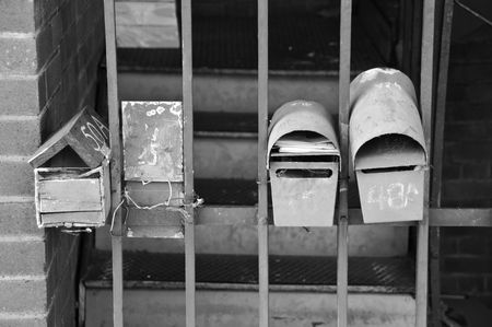A collection of mailboxes, old and rusted, but still in use