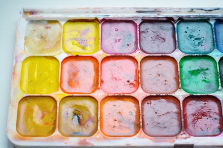 Old used watercolor paint box top down viewの写真素材