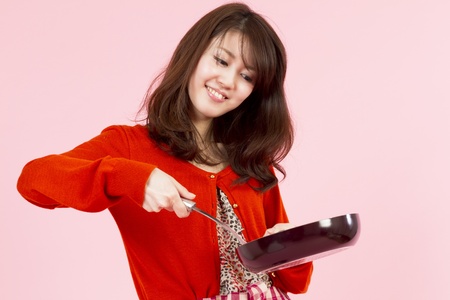 Cooking young woman の写真素材