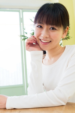 Beautiful young woman in the room の写真素材