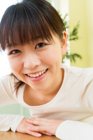 Beautiful young woman in the room の写真素材
