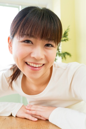 Beautiful young woman in the room の写真素材
