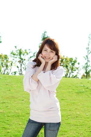 Beautiful young woman on the green  Portrait of asian woman  の写真素材