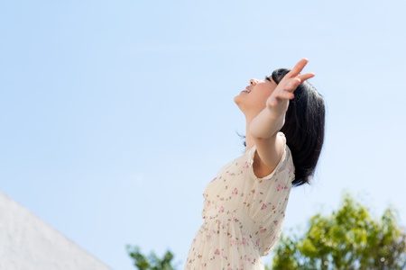 Beautiful young woman outdoors over blue skyの写真素材