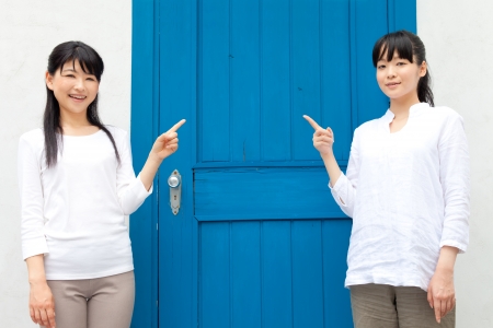 Beautiful young women outside the houseの写真素材
