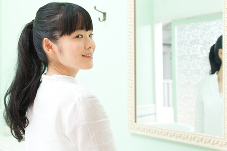 Beautiful young woman in bathroomの写真素材