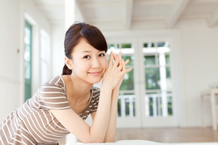 Beautiful young woman relaxing in the roomの写真素材
