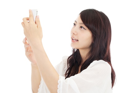 Beautiful young woman using a cellular  Portrait of asian の写真素材