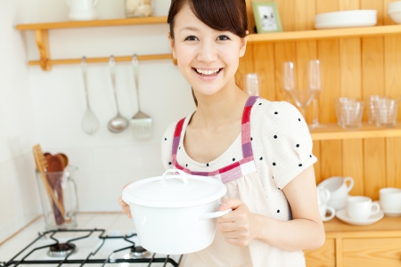 Beautiful young woman relaxing iin the kitchenの写真素材