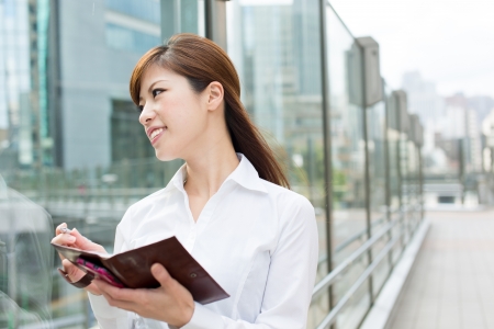 Beautiful business woman walking outside her officeの写真素材