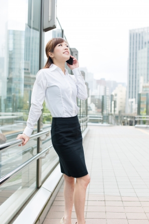 Beautiful business woman walking outside her officeの写真素材