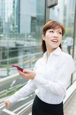 Beautiful business woman walking outside her officeの写真素材