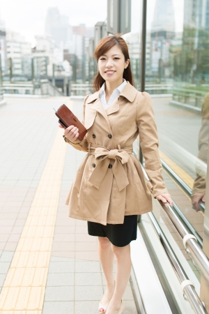 Beautiful business woman walking outside her officeの写真素材