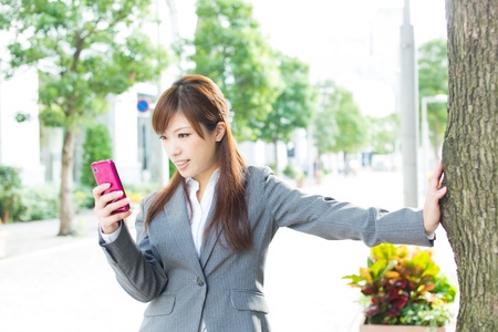 Beautiful businesswoman using a cellular phoneの写真素材