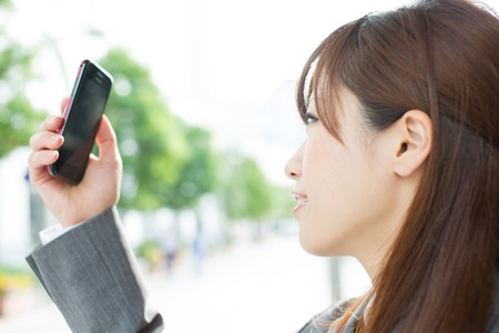 Beautiful businesswoman using a cellular phoneの写真素材