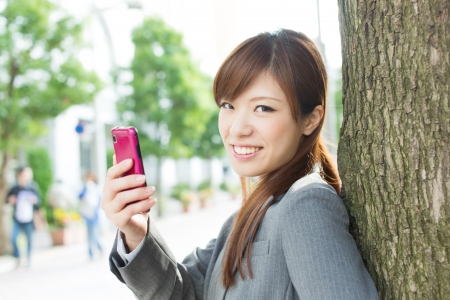 Beautiful businesswoman using a cellular phoneの写真素材