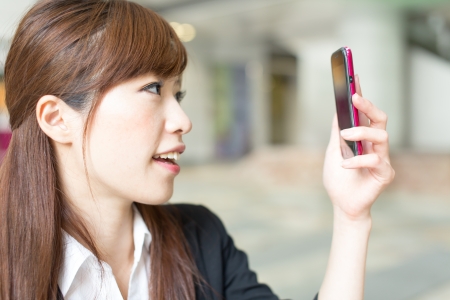 Beautiful businesswoman using a cellular phoneの写真素材