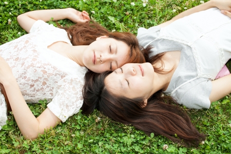 Beautiful young women on green fieldの写真素材
