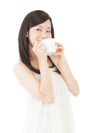 Beautiful asian woman drinking coffee on white backgroundの写真素材