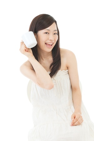 Beautiful asian woman drinking coffee on white backgroundの写真素材