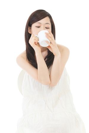 Beautiful asian woman drinking coffee on white backgroundの写真素材