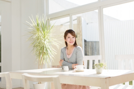 Beautiful young woman relaxing roomの写真素材