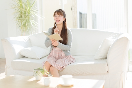 Beautiful young woman relaxing roomの写真素材