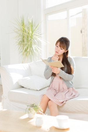 Beautiful young woman relaxing roomの写真素材