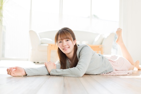 Beautiful young woman relaxing roomの写真素材
