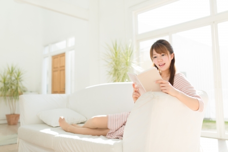 Beautiful young woman relaxing roomの写真素材