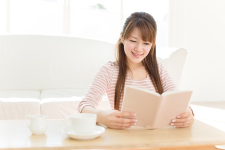 Beautiful young woman relaxing roomの写真素材
